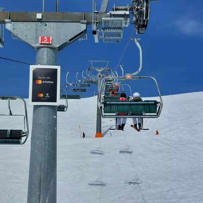 Ski lift pylon advertising with Mastercard motif in the KitzSki ski area in Kitzbühel, Austria