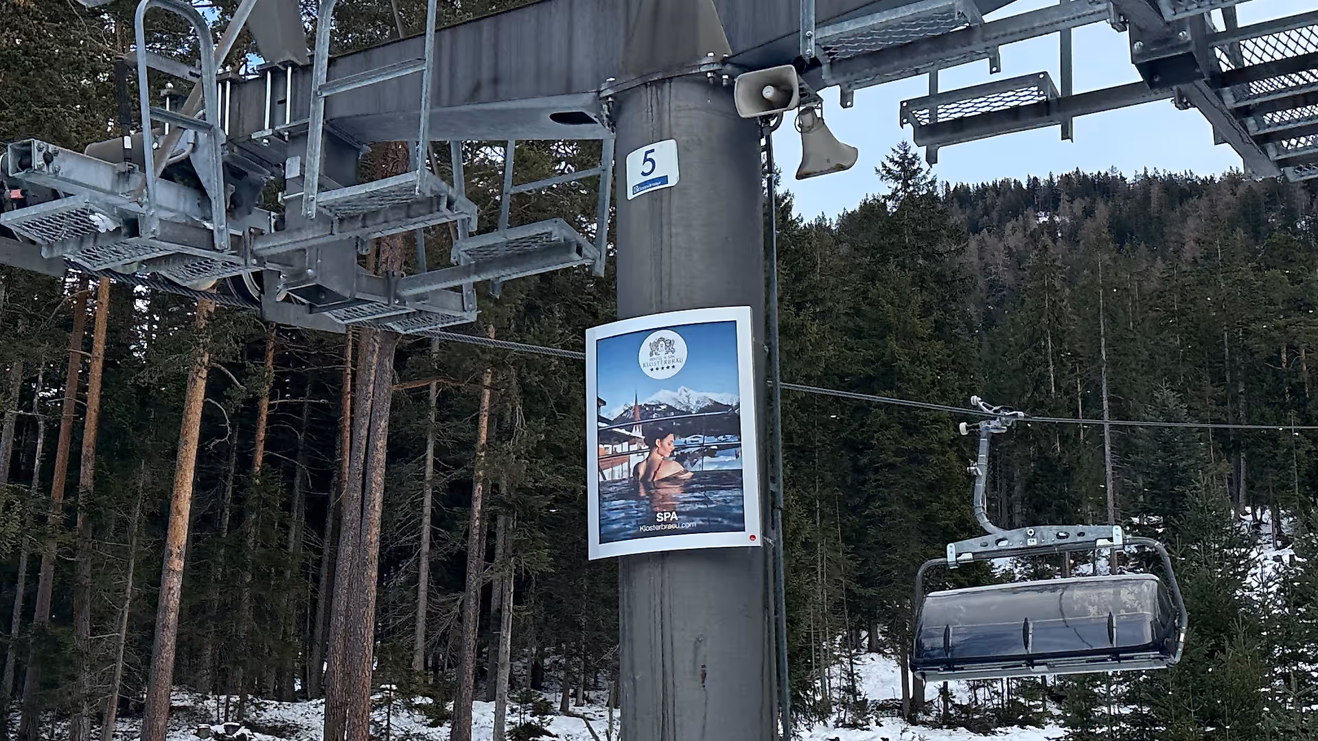 Wellness-themed billboard by Hotel Klosterbräu on a lift tower in Seefeld ski resort